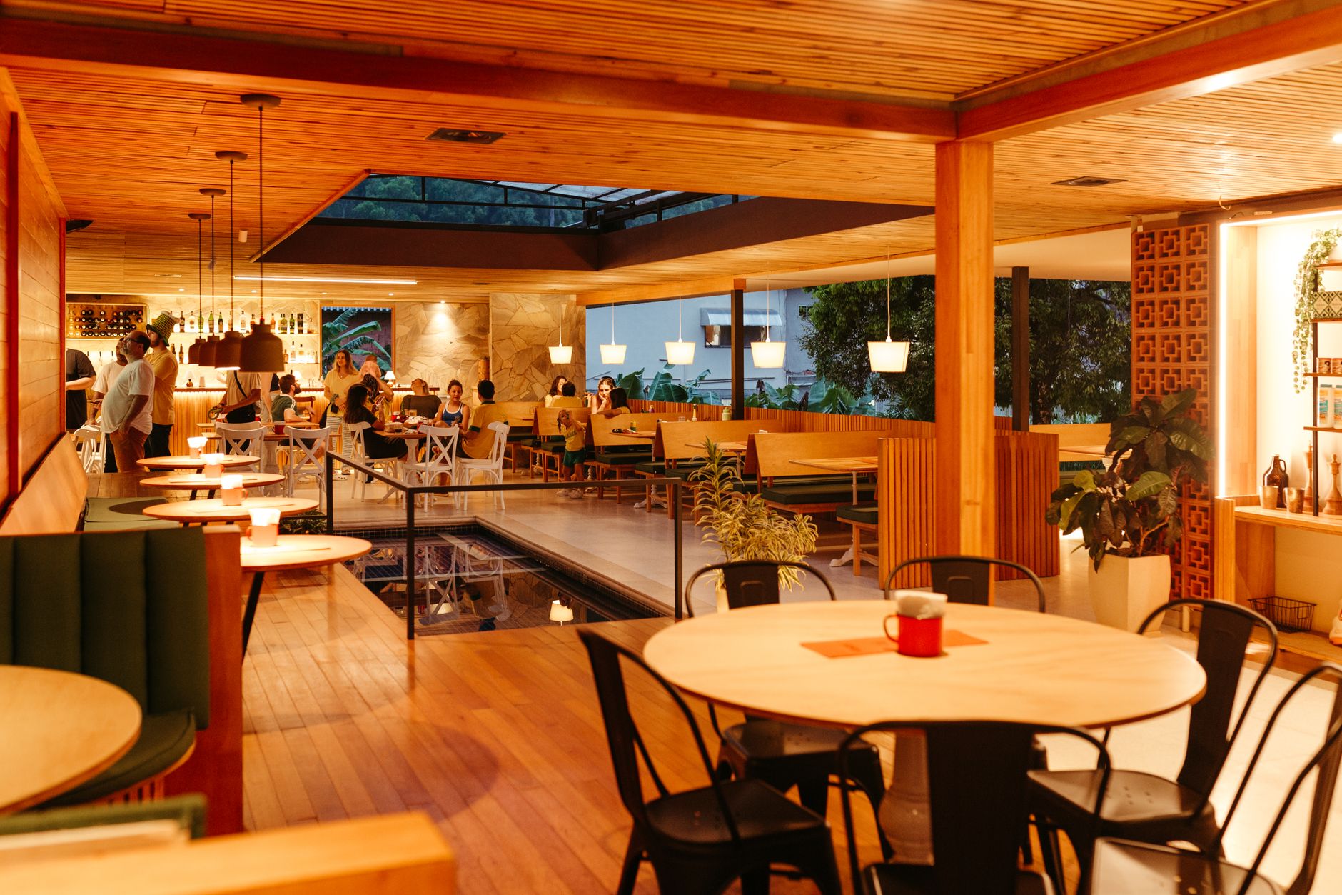 Warm, dimly lit restaurant dining room with wooden decor and ambient lighting