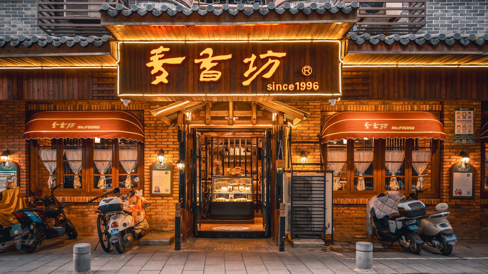 A beautifully lit traditional restaurant storefront exterior with warm tones